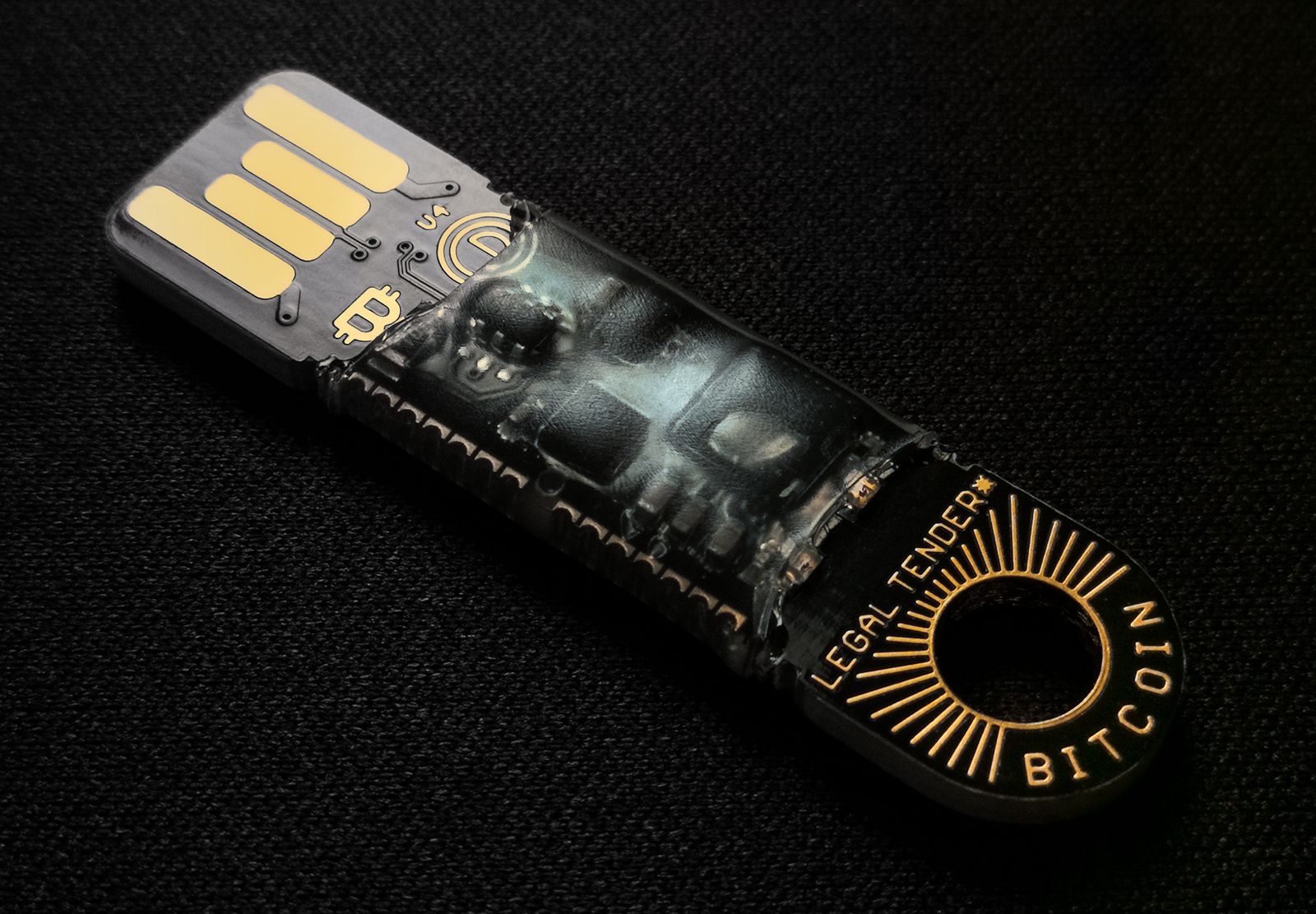 Dispositivo de armazenamento físico conectado a um cabo, sobre fundo escuro, representando a carteira de hardware e a investigação das seeds expostas no ataque à Coldcard